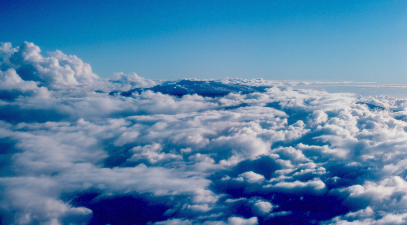 Maui peaking through the clouds as seen from aircraft (Image credit: Commander John Bortniak) Maui peaking through the clouds as seen from aircraft