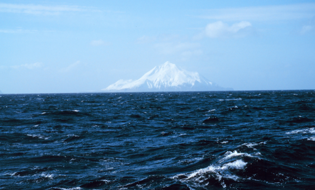 An Aleutian Island peak looms in the distance (Image credit: Personnel of NOAA Ship MILLER FREEMAN) An Aleutian Island peak looms in the distance