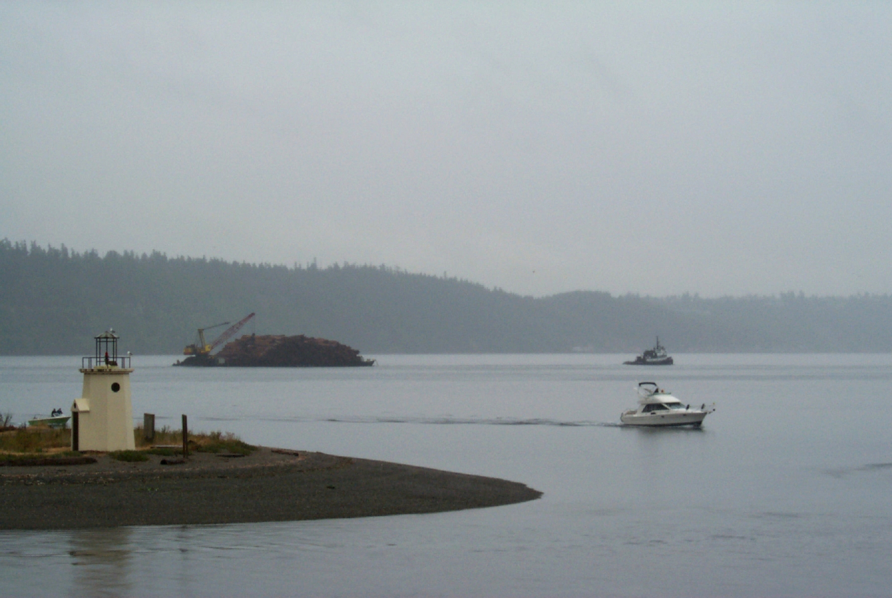 Looking past the spit at Gig Harbor to a barge-load of pine bark headed forto Steilacoom (Image credit: Carol Baldwin) Looking past the spit at Gig Harbor to a barge-load of pine bark headed forto Steilacoom