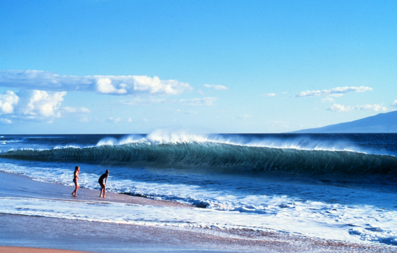 Two vacationers dwarfed by the shorebreak as an offshore wind whips spray offthe crest of the wave (Image credit: Ralph F. Kresge) Two vacationers dwarfed by the shorebreak as an offshore wind whips spray offthe crest of the wave