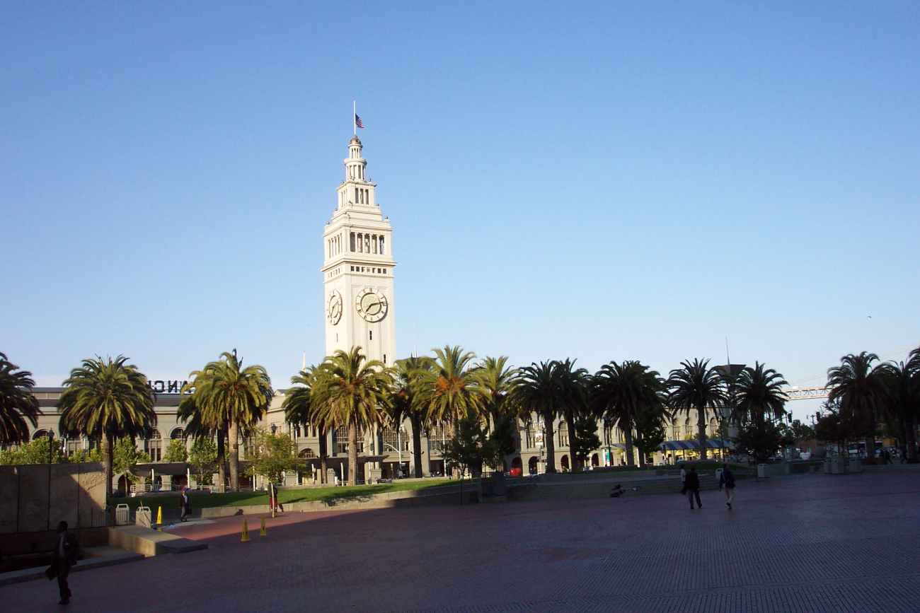 The Ferry Building and palm trees along the Embarcadero illuminated in the lateafternoon sun