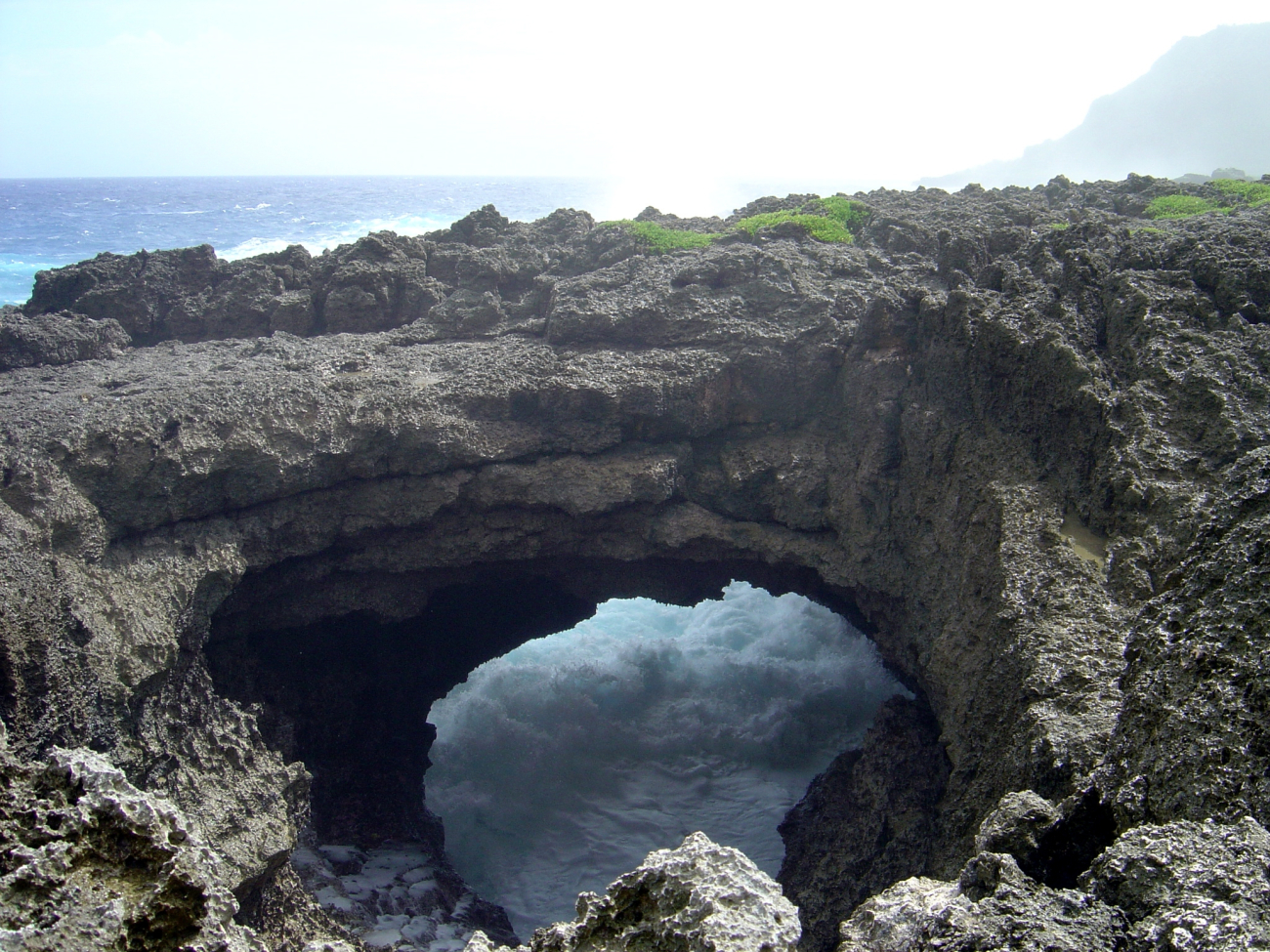 Roaring surf seen through a beautiful natural stone arch on the coast of Guam (Image credit: David Burdick) Roaring surf seen through a beautiful natural stone arch on the coast of Guam