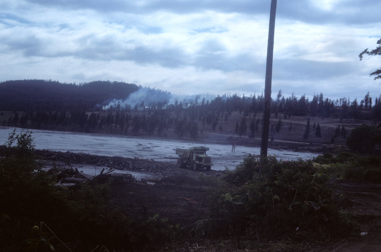 Burning brush on hillside, dump truck filling in tidal wetland area (Image credit: NOAA Central Library Historical Collections) Burning brush on hillside, dump truck filling in tidal wetland area
