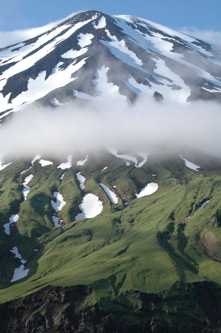 A ribbon of cloud bisecting the snow covered upper reaches of Tanaga Volcanofrom the moss covered lower slopes (Image credit: Mandy Lindeberg) A ribbon of cloud bisecting the snow covered upper reaches of Tanaga Volcanofrom the moss covered lower slopes