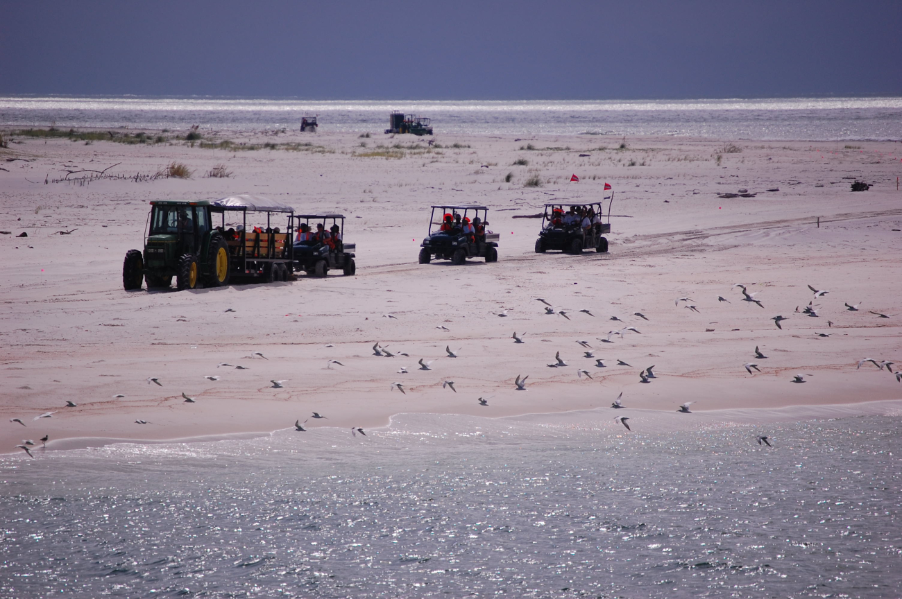 Tractor transportation for workers helping clean beaches following DeepwaterHorizon disaster (Image credit: Officers and Crew of NOAA Ship PISCES; Collection of Commander Jeremy Adams, NOAA Corps) Tractor transportation for workers helping clean beaches following DeepwaterHorizon disaster
