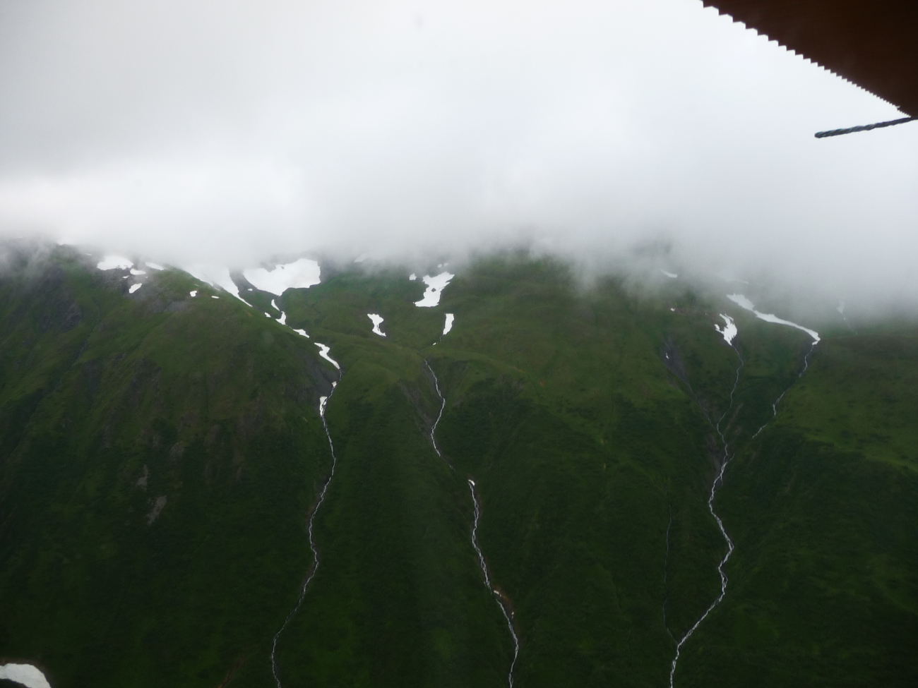 Aerial view of silver ribbons of falling water trickling to the sea (Image credit: Jenny Thacker) Aerial view of silver ribbons of falling water trickling to the sea