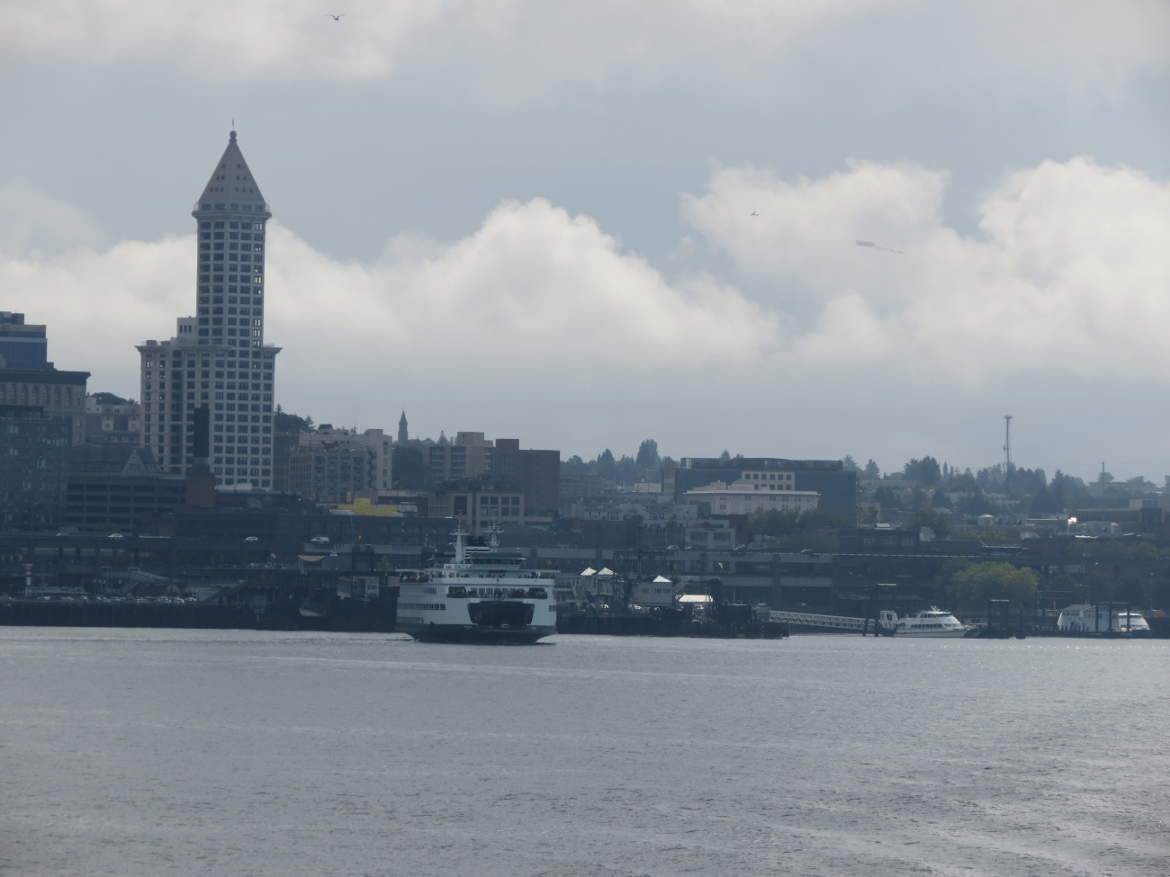 The Smith Building -Seattle's oldest skyscraper, a Seattleferryboat, and an advertising airplane flying above (Image credit: Crew and Officers of NOAA Ship FAIRWEATHER) The Smith Building -Seattle's oldest skyscraper, a Seattleferryboat, and an advertising airplane flying above
