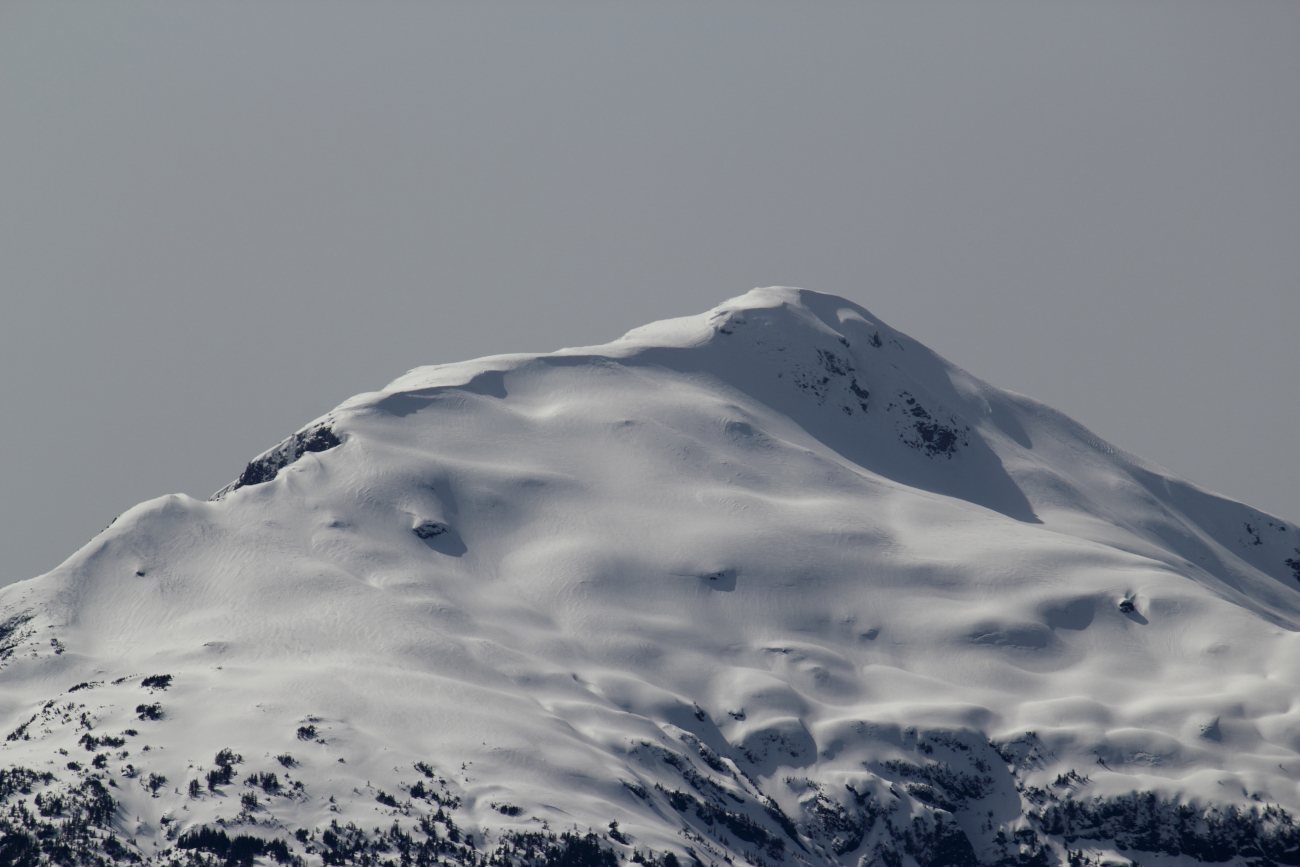 A snow-covered mountain peak seen along the Behm Canal