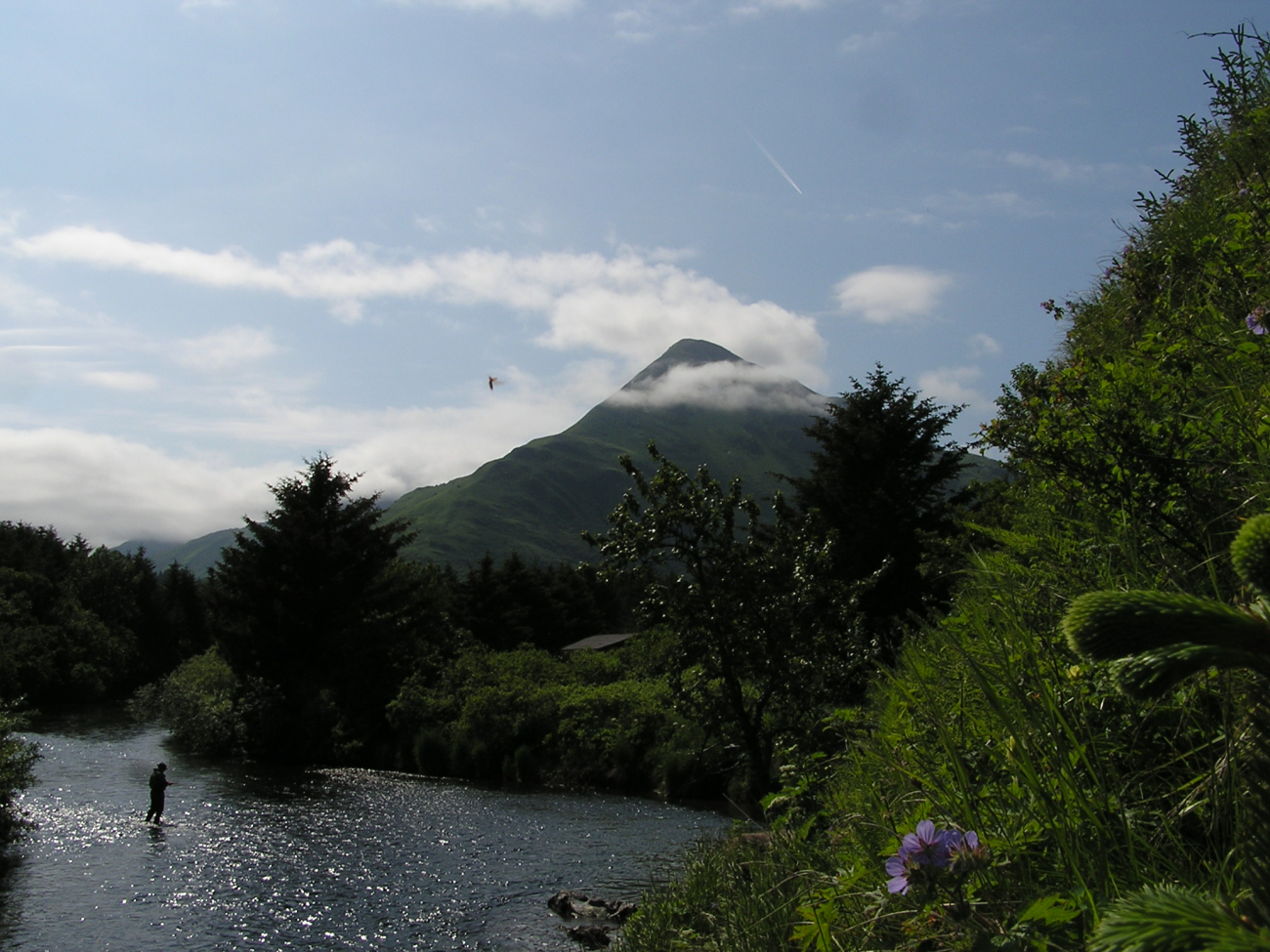 Idyllic view of fisherman in Kodiak stream with Barometer Mountain in thebackground (Image credit: Crew and Officers of NOAA Ship FAIRWEATHER) Idyllic view of fisherman in Kodiak stream with Barometer Mountain in thebackground