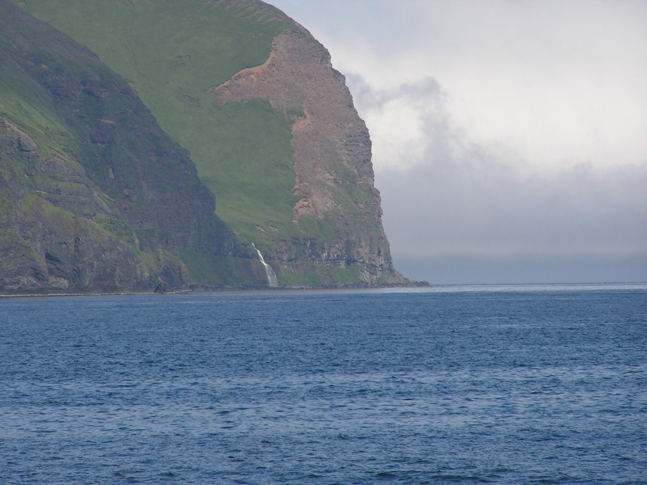 A waterfall rushing to the sea between impressive Aleutian cliffs (Image credit: Crew and Officers of NOAA Ship FAIRWEATHER) A waterfall rushing to the sea between impressive Aleutian cliffs