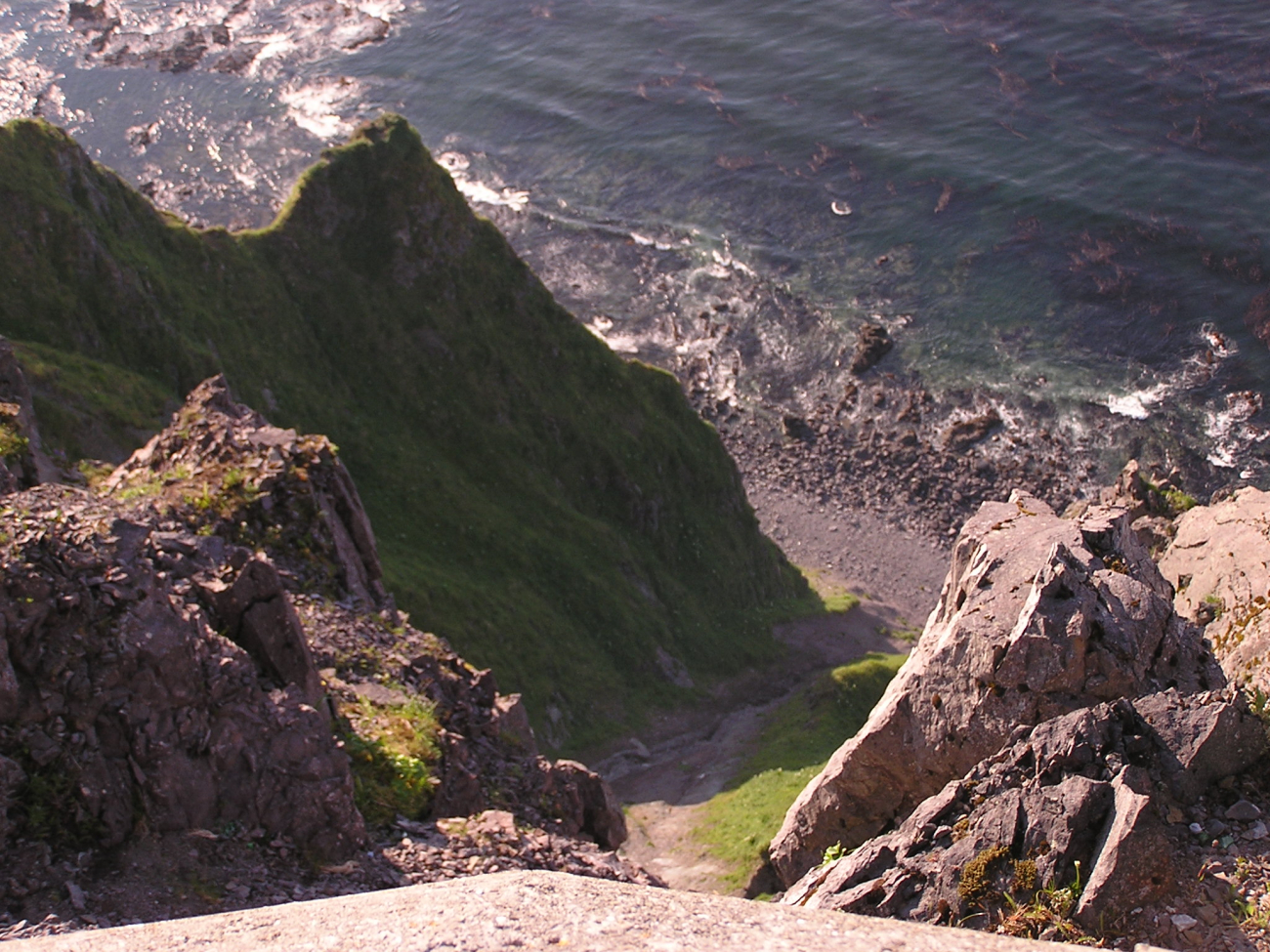 A vertiginous view of the kelp beds and shoreline below from aWorld War II bunker at Dutch Harbor