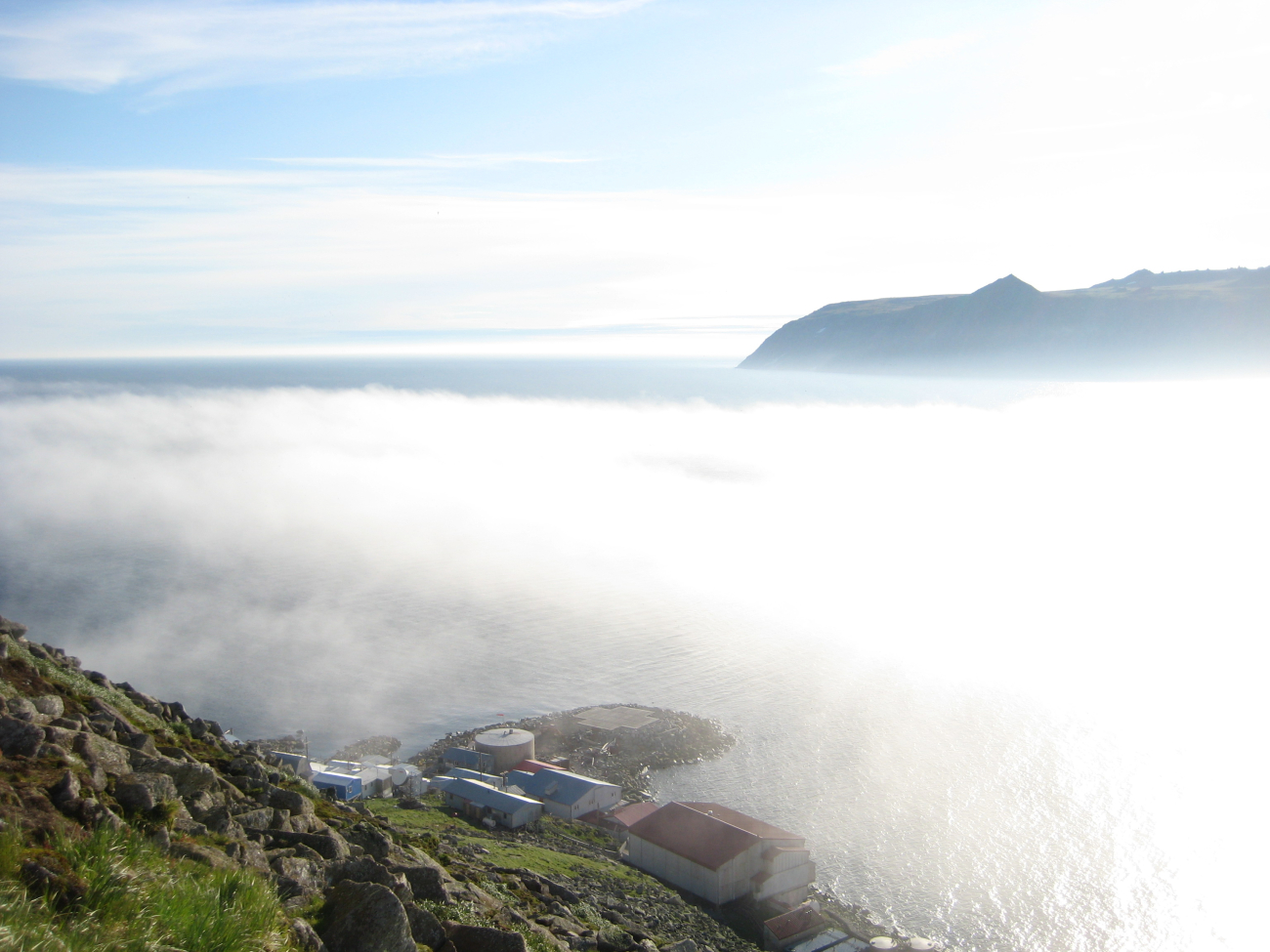 Looking over the village at Little Diomede Island to the fog shrouded straitbetween Little Diomede and Big Diomede Islands (Image credit: Crew and Officers of NOAA Ship FAIRWEATHER) Looking over the village at Little Diomede Island to the fog shrouded straitbetween Little Diomede and Big Diomede Islands