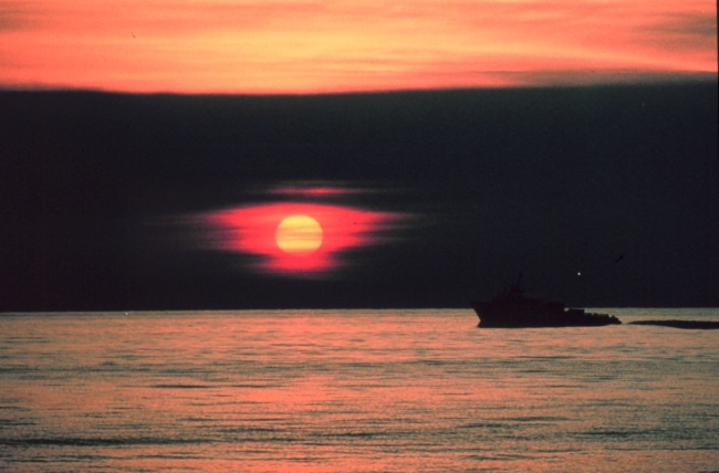 A gulf crew boat silhouetted in a Gulf of Mexico sunset