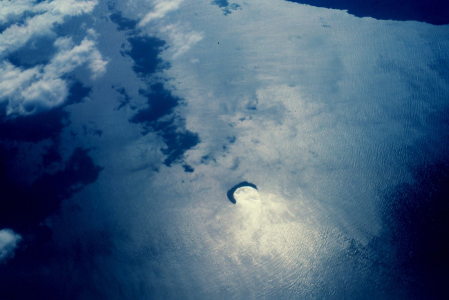 Molokini Island, a crescent island, is rim of volcanic crater opening to northShore of Kahoolawe is visible in upper right