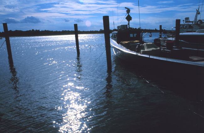 A commercial lobster boat tied up in the late afternoon sunshine