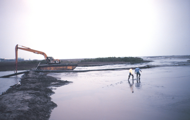 The Greenhill/East Timbalier dredge deposition  --  backhoe is used to move pipe to evenly distribute the dredge material