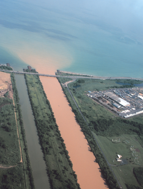 A heavily silted river enters the ocean near San Juan