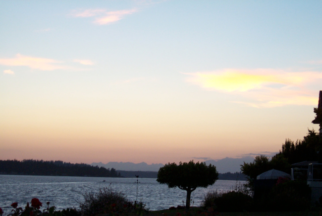 The Olympic Range is silhouetted in this sunset view from Gig Harbor
