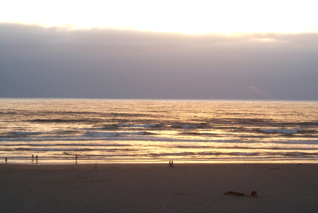 Sun setting behind an offshore fog bank at Seaside