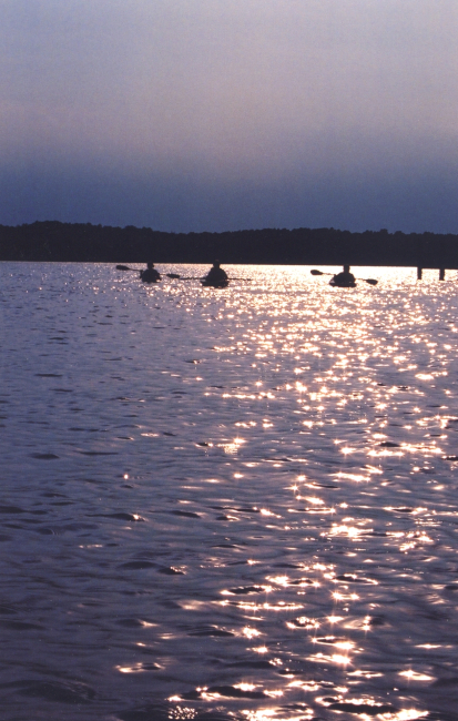 Late afternoon sun-glint on the lower Patuxent River silhouetting a group ofkayakers