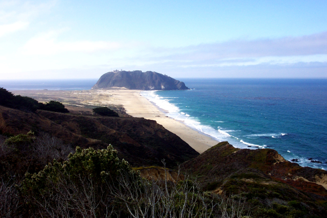Looking down a pristine beach toward Point Sur