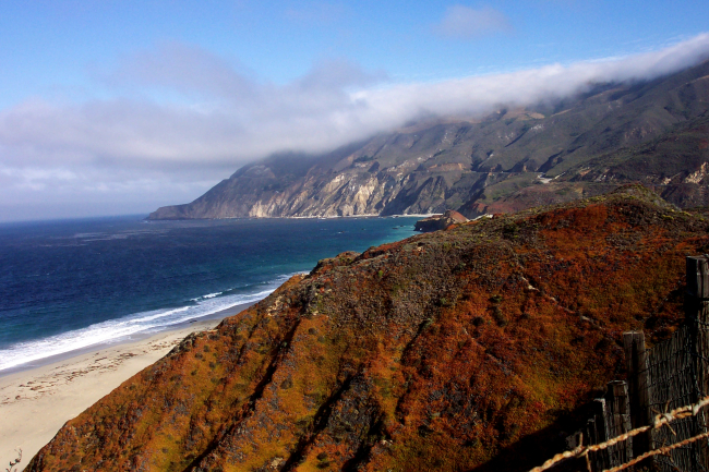 Looking north along the Big Sur coastline with fog-shrouded peaks