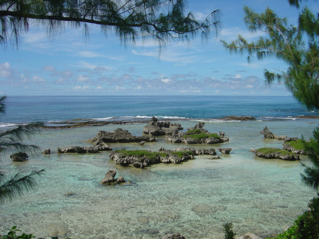 Coral rock islets in the reef flat behind the edge of the reef on Guam