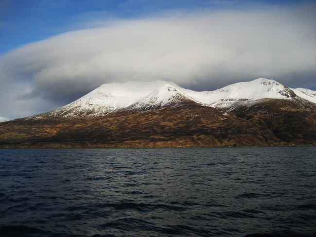 Clouds over snow-covered mountains