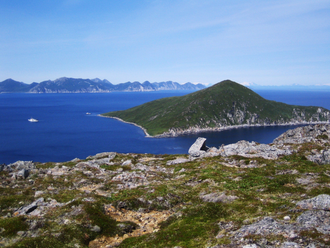 The view from the top of Little Koniuji Island looking across the Shumagins towards the snow-covered peaks of  the Alaska Peninsula