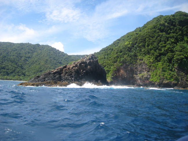 An offshore basaltic rock continually battered by the sea