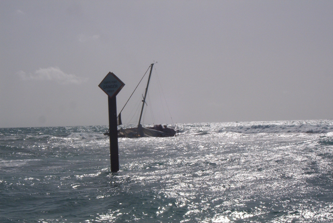 Carysfort Reef Lighthouse with derelict sailboat