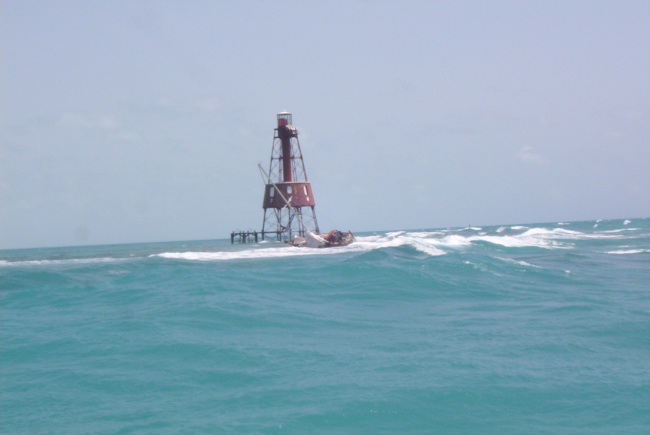 Carysfort Reef Lighthouse with derelict sailboat
