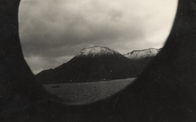 Porthole view of snow-covered Aleutian Islands