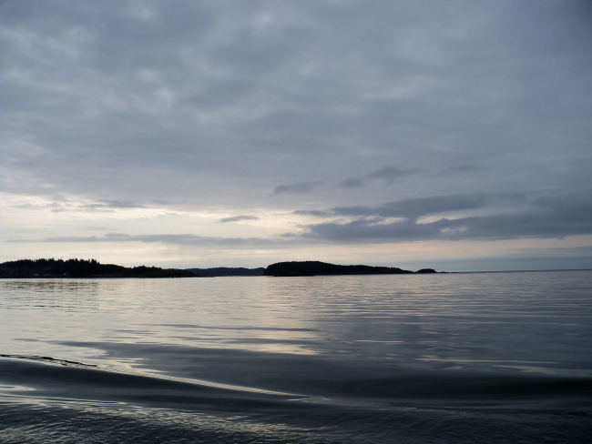 A rare day of glassy smooth waters on the Alaska shoreline