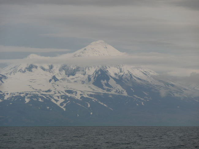 Mount Pavlof rising above layers of cloud