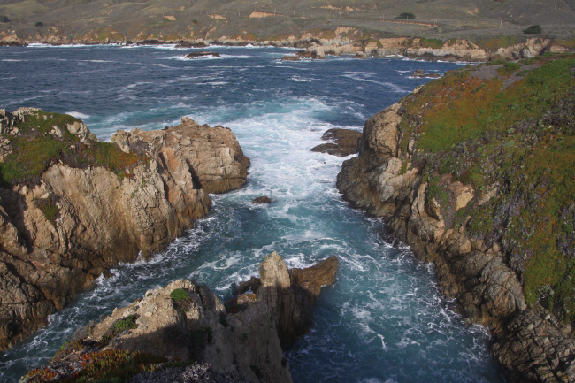 Rocky canyons opening to the sea eroded by the incessant action wavespounding against seemingly, but not, indestructible granite