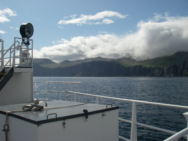 Clouds pouring over an Aleutian island