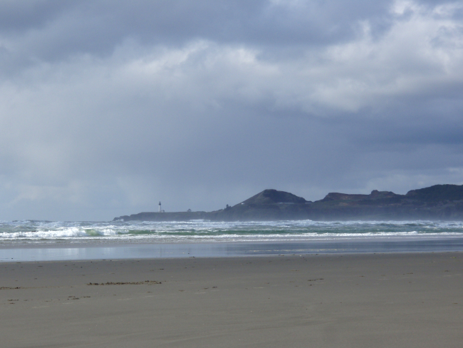 The beach at Newport with Yaquina Head Lighthouse in the distance