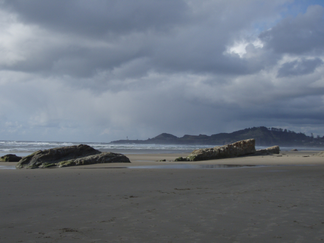 The beach at Newport with Yaquina Head Lighthouse in the distance