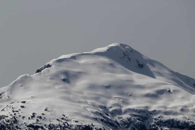 A snow-covered mountain peak seen along the Behm Canal